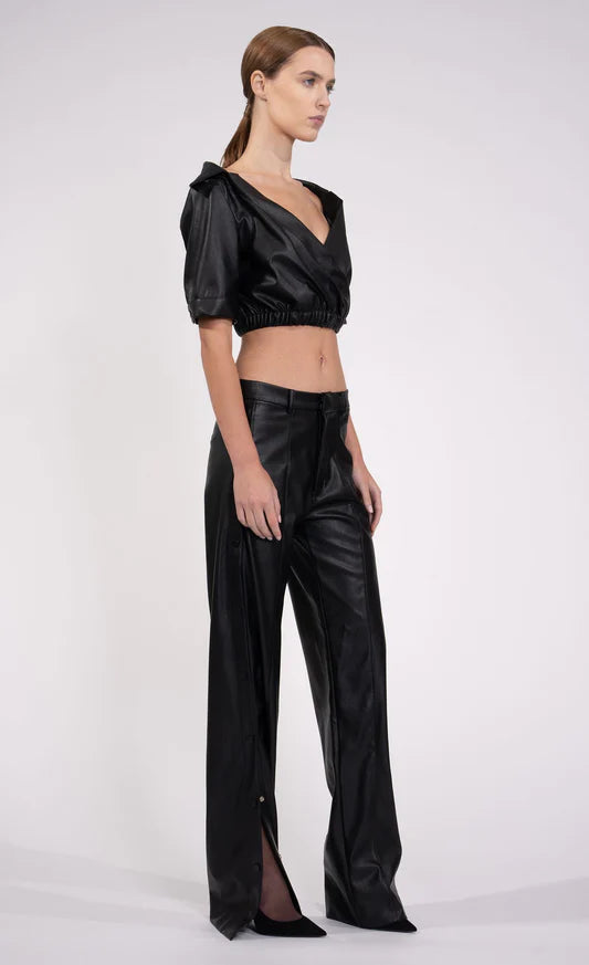 Kate Top by Nonchalant | Introducing the Kate Top, your ultimate wardrobe essential for injecting a dose of bold flair. This leather off-the-shoulder crop effortlessly combines sophistication with a hint of daring style. Crafted with an elasticized waistband to ensure an impeccable fit, the Kate Top is your go-to choice. Pair with the matching Julia Pant. 100% PU Leather True To Size Model Wears XS Model Height 5'9 | Coretrade located in Boca Raton, FL